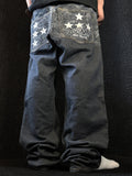 MM like black baggy jeans, dark indigo denim – tonal wave pattern with white stars across the yoke and back pockets – side view, worn – vintage Y2K, size W32 / M, ships from Germany / Versand aus Deutschland